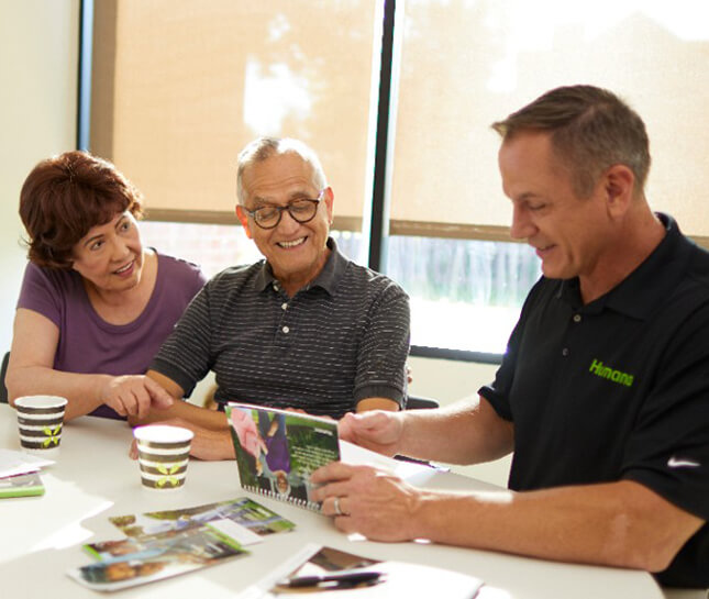 Humana agent speaking with an older couple.